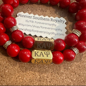 Gold and red Kappa Alpha Psi bracelet.