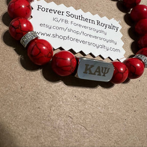 Red Kappa Alpha Psi bracelet.