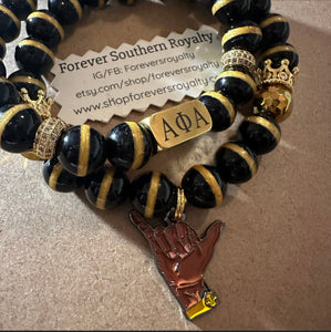 Black and gold Alpha bracelet set.