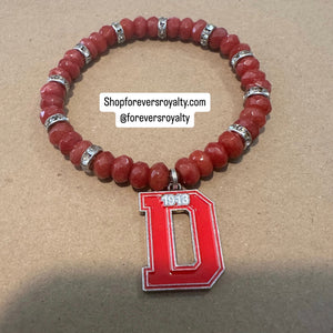 Red D bracelet.