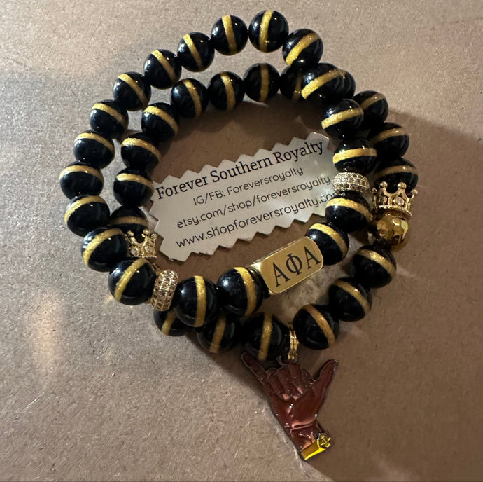 Black and gold Alpha bracelet set.