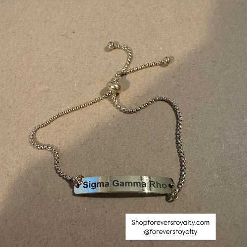 The gold Sigma Gamma Rho bracelet.