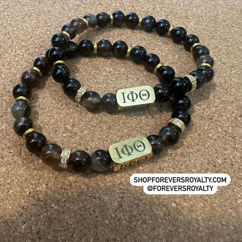 Gold Iota Phi Theta bracelet.