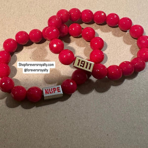 Red NUPE bracelet.