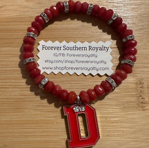 Red D bracelet.