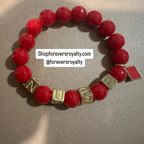 The red NUPE letter bracelet.