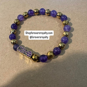 The purple and gold bracelet.