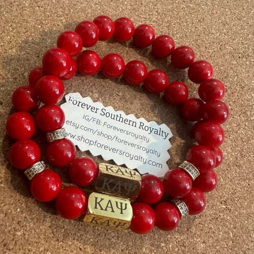 Gold and red Kappa Alpha Psi bracelet.