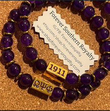 Load image into Gallery viewer, Purple Omega Psi Phi bracelet with gold.